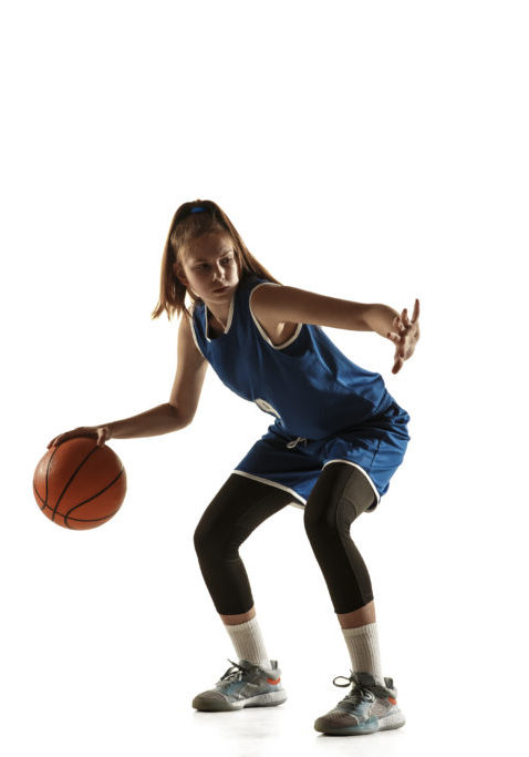 Young caucasian female basketball player of team in action, motion in run isolated on white background. Concept of sport, movement, energy and dynamic, healthy lifestyle. Training, practicing.